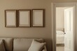 © matoya - Beige living room, three empty frames, open doorway, bedroom view, mockup