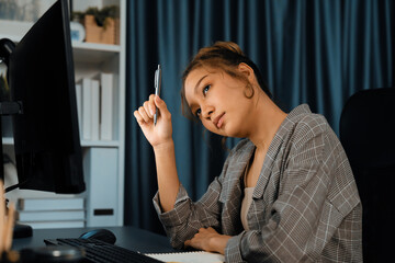 Wall Mural - Businesswoman working on computer with stretching arm up and down manner with body health ache of strain overwork unfinished project job on website at late over night time at modern office. Infobahn.