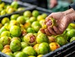 © pprothien - Hand rejecting rotten fruit at market. Food safety and contamination image concept.