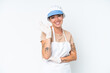 © luismolinero - Fishmonger wearing an apron and holding a raw fish isolated on white background saluting with hand with happy expression