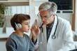 © Viktoriia - Doctor consulting child with headphones, emphasizing attentive c
