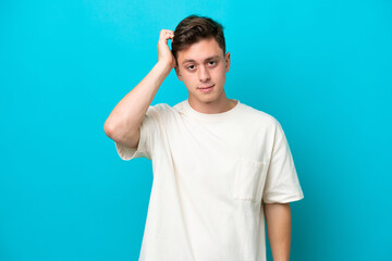 Young handsome Brazilian man isolated on blue background with an expression of frustration and not understanding