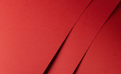 Poster - Fiery red paper background with overlapping diagonal sheets. Bold warm tones, vibrant geometric patterns, and grainy textures create a stylish, striking, and elegant composition.