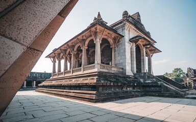 Wall Mural - Ancient stone pavilion with intricate carvings and tiered base.