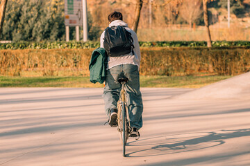 young man on the street riding on vintage bicycle