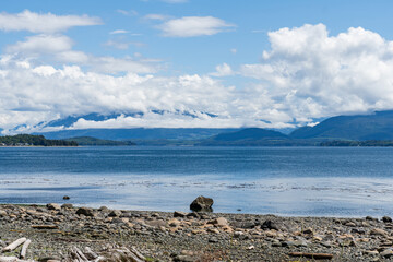 Wall Mural - view from the shore of Malcolm Island beautiful water of the Queen Charlotte Strait with clouds on sky