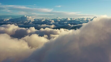 Wall Mural - flying above the clouds. aerial view of clouds at sunrise. traveling by air perfect background, 4k