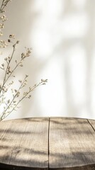 Poster - Empty round wooden table illuminating by window light with dried flower decoration creates a cozy and inviting atmosphere in a kitchen setting