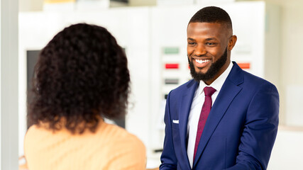 Wall Mural - Smiling Car Seller Shaking Hands With Female Customer After Successful Deal, Unrecognizable African American Woman Buying New Vehicle In Dealership Center, Purchasing Automobile In Modern Showroom