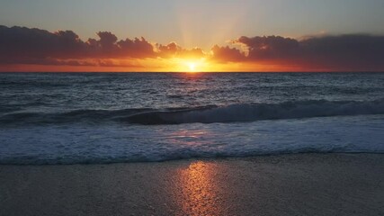 Wall Mural - stunning sunset over sea with vibrant colors reflecting on the water at the beach, 4k