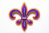 Studio shot of a fleur de lis symbol, crafted with purple, orange, and teal beads, creating a vibrant and festive decoration