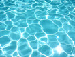 © Siasart - Sparkling turquoise water surface reflects sunlight in a swimming pool. Summer background with light reflections.