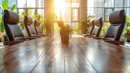 Wall Mural - A sunlit modern meeting room featuring a long wooden conference table surrounded by sleek leather chairs and green plants, providing an inviting and professional atmosphere
