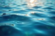© Viktor - Close-up view of light blue water surface with soft waves, reflections. Water shimmers, sparkles. Vivid blue color, abstract patterns are visible. Perfect for summer design or ocean background.