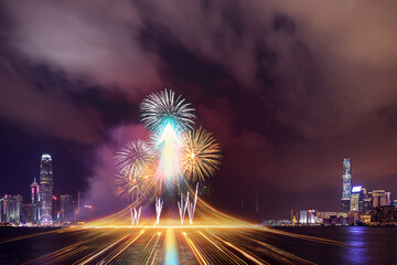 Poster - Vibrant fireworks explode over Hong Kong's glittering skyline at night, their colorful bursts reflected in the water, creating a stunning urban spectacle. Light trails streak across the foreground, ad