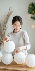 Poster - Young Woman Arranging Lanterns for Festive Eco-Friendly Celebration