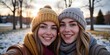 © Natsumae - Twin sisters' winter selfie: radiant smiles, cozy knit hats, snowy backdrop. Pure joy captured!