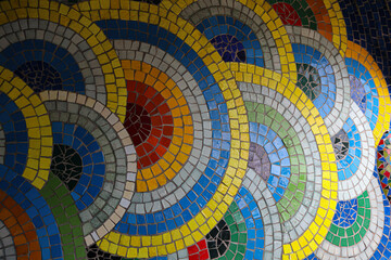 Intricate mosaic design featuring vibrant blue white and yellow patterns in a circular format. Colorful background mosaic tile design.Colorful mosaic pattern featuring circular shapes. showcases stone