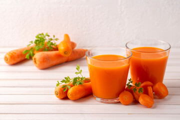 Wall Mural - Carrot juice in a glass and fresh carrots