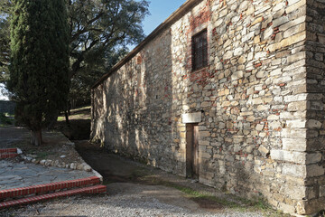 Stone medieval building on mountain on sunny day. Liguria and traditional old building. Sestri Levante, town by sea. 