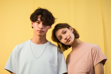 Wall Mural - A man and a woman are standing next to each other, both wearing white shirts