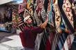 © Westend61 - Man choosing shawls at market