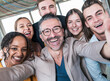 © Westend61 - Happy businessman taking selfie with colleagues in office
