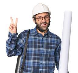 Hispanic male architect with plans joyful and carefree showing a peace symbol with fingers.