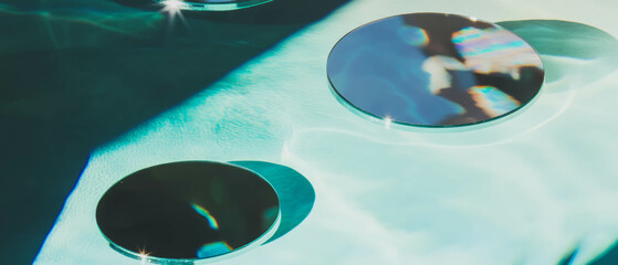 Poster - Reflective small round mirrors create playful patterns of light in scattered arrangement
