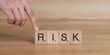 © TarikTalha - Risk Word on Wooden Tile Block.  business planning to reduce risk with information and decision making.