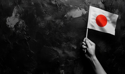 Poster - Japanese flag held against dark textured background, symbolizing Japan's culture and identity