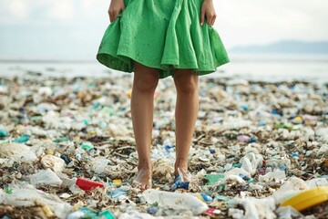 Poster - A woman stands amidst a pile of garbage on a polluted beach, highlighting the issue of waste management