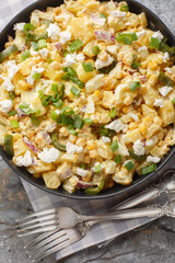 Wall Mural - Mexican corn potato salad with eggs, onions and pickled jalapeno peppers close-up in a bowl on the table. Vertical top view from above