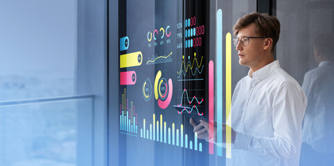 Poster - Businessman analyzing holographic data charts on transparent scr