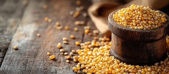 Poster - Grain Mill with Corn Kernels on Rustic Wooden Surface Empty Space for Text and Background Use