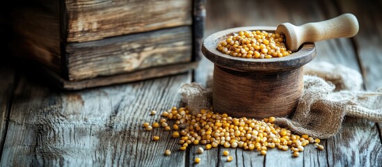 Poster - Wooden Grain Mill with Corn Kernels and Scoop on Rustic Table for Text Placement and Culinary Themes
