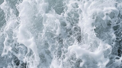 Poster - Textured close-up of turbulent ocean waves with foam creating a dynamic abstract background for design and nature themes.