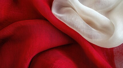 Poster - Elegant red and white fabric texture showcasing a delicate interplay of colors and folds for fashion and design concepts