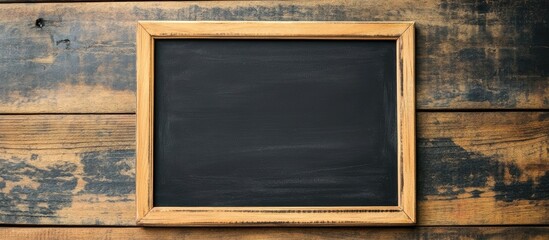 Poster - Chalkboard mockup on rustic wooden table with empty space for text ideal for educational or promotional content creation
