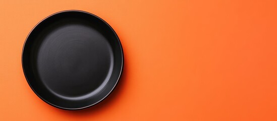 Aufkleber - Black Ceramic Tray on Vibrant Orange Surface with Empty Space for Custom Text or Branding for Creative Projects and Advertisements