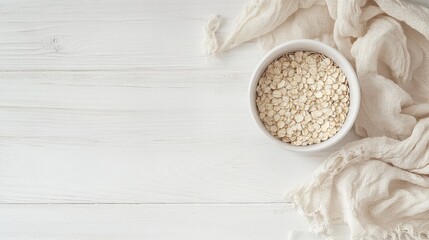 Aufkleber - Bowl of raw rolled oats on white wooden table with empty space for text and natural linen cloth for a rustic kitchen aesthetic
