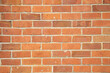 © Connect Images - Orange brick wall with a classic staggered pattern and visible mortar joints, Auckland, New Zealand