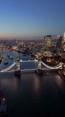 Wall Mural - Panoramic aerial night view of the illuminated Tower Bridge and skyline of London, England