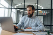 © standret - Focused at work. Businessman is in the office