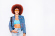 © ADDICTIVE STOCK - Smiling woman with afro hair wearing stylish denim jacket