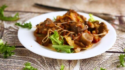 Wall Mural - vegetable stew with eggplants, on a wooden table