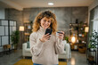 © Miljan Živković - adult woman with curly hair use cellphone and credit card for payment
