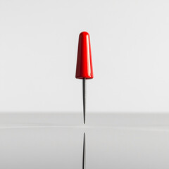 Poster - Minimalist red pin with sharp reflection on a glossy white surface
