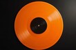 © Bianca - Bright orange vinyl record with a black center label on a sleek black background, showcasing vibrant retro audio aesthetics