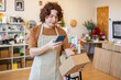 © ADDICTIVE STOCK - Small Business Owner of Organic Products Checking Package in Store